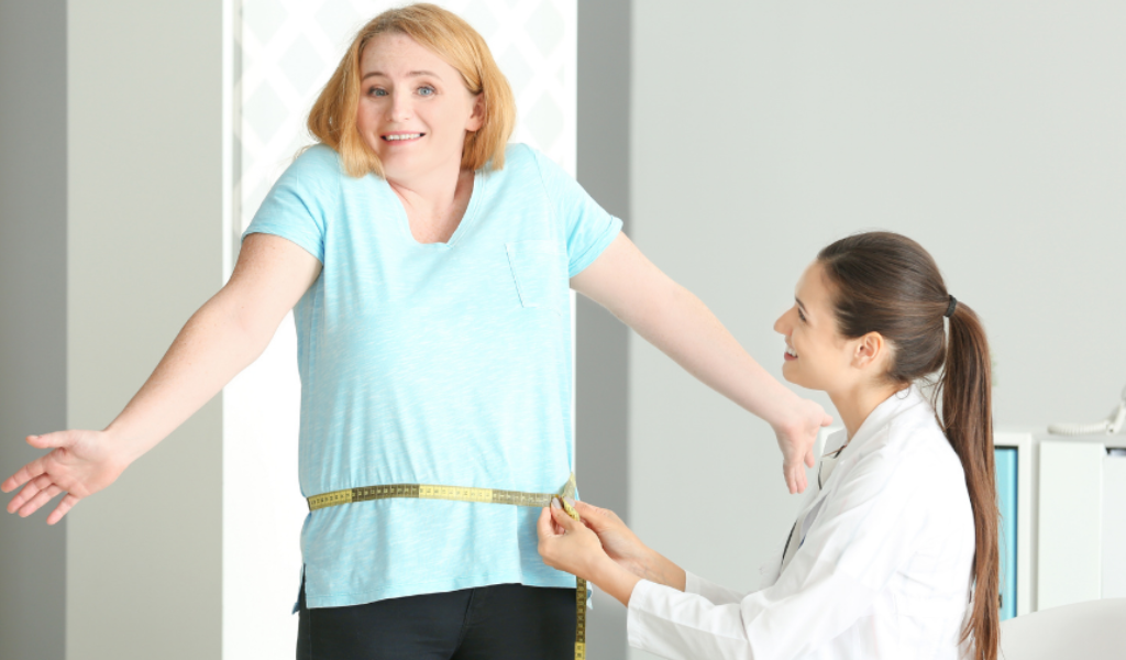 overweight woman being measured at a diet center , medical weight loss